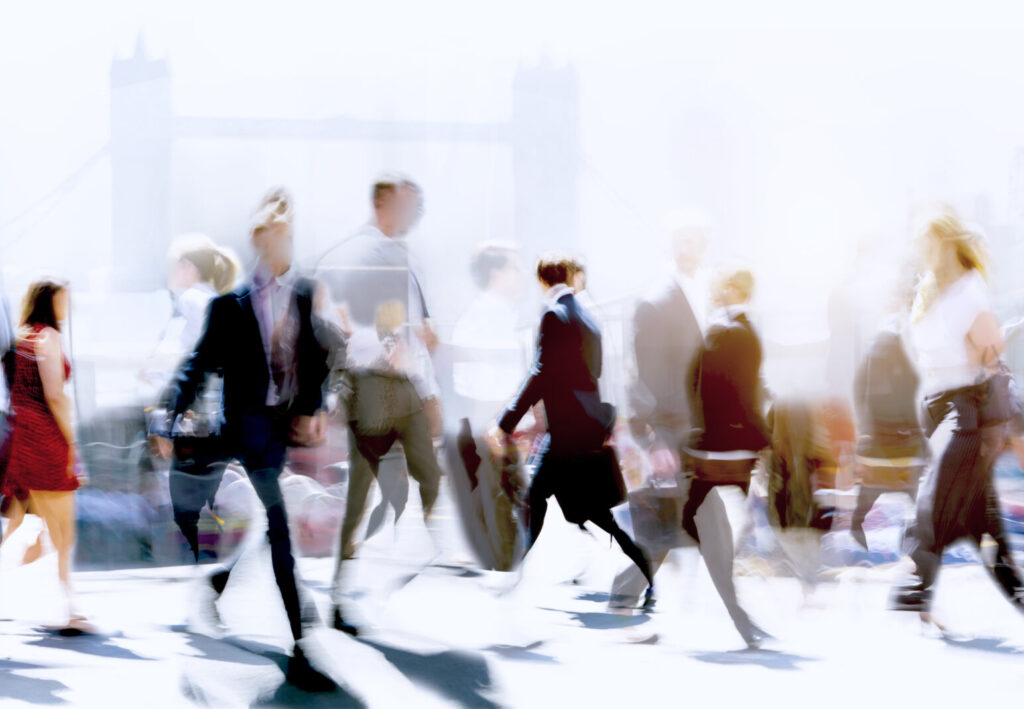 Blurred graphic of business people walking around the city in front of the Tower of London