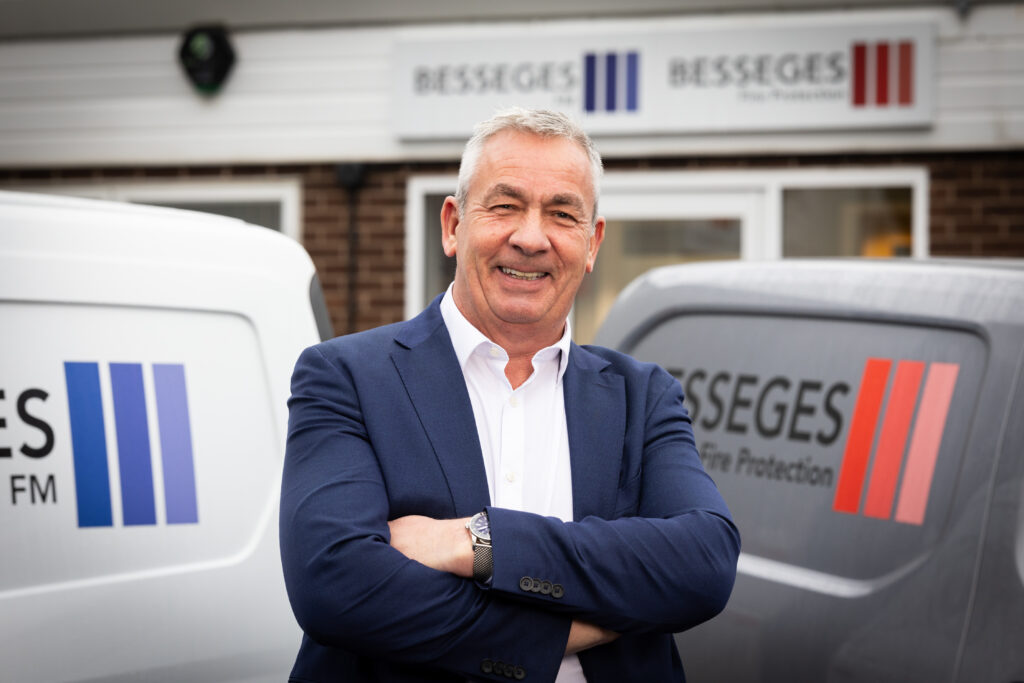 David Prendergast, CEO at Besseges, in front of office and branded vans